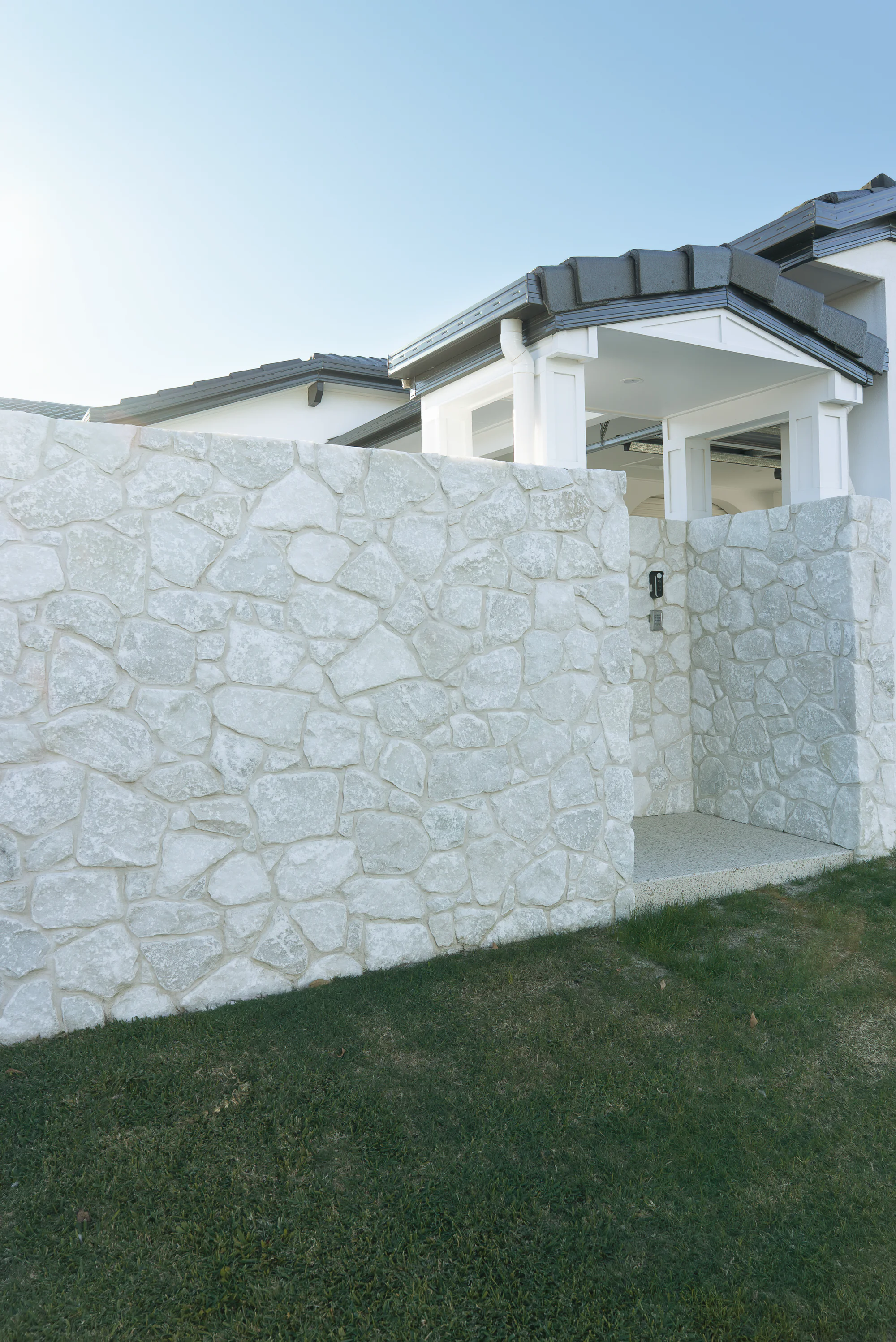 White natural stone feature wall at a front entry